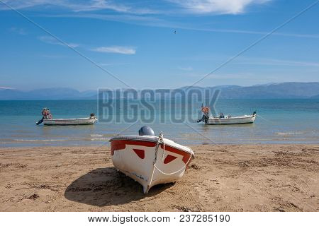 Three Boats At The Beach At Kavos In Corfu, Greece