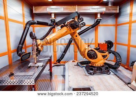 Fibre laser robotic remote cutting system. CNC Laser plasma cutting of metal, modern industrial technology.