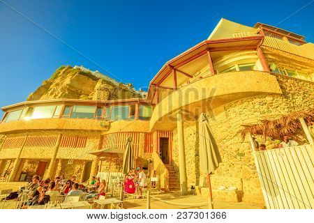 Azenhas Do Mar, Portugal - August 5, 2017: Bottom View Of Restaurant And High Cliff Of Ex Fishing Vi