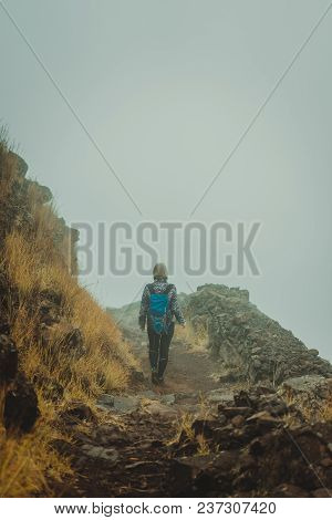 Woman Hiker On The Cobbled Misty Path On The Mountain Crest On Santo Antao Island, Cape Verde.