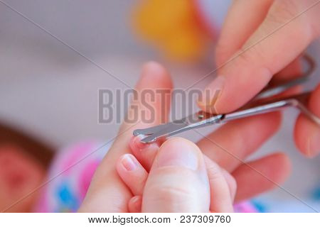 Cutting Newborn Baby Nails With Scissors Close.