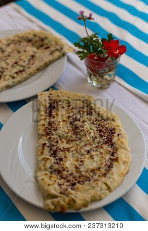 Flatbread On Striped White And Blue Tablecloth