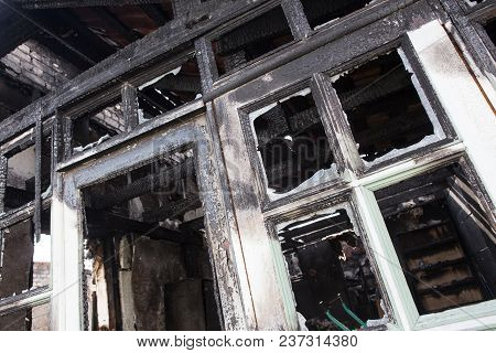 Facade Of The Burned-down Wooden House Photo