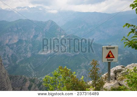 At The Top Of The Mountain There Is A Sign Warning Of The Danger Of Falling From A Height.