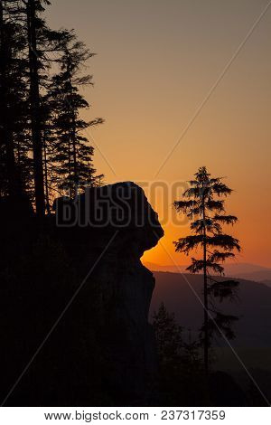 A Silhouetted Sandstone Cliff And Trees At Sunset On Ostas Hill In Northern Czech Republic