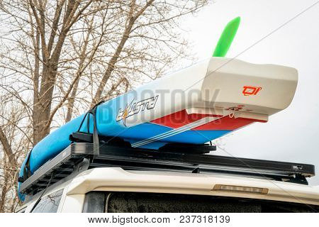 Fort Collins, CO, USA - April 7, 2018: A racing stand up paddleboard by Starboard (2018 All Star model) on roof racks of Toyota 4Runner.