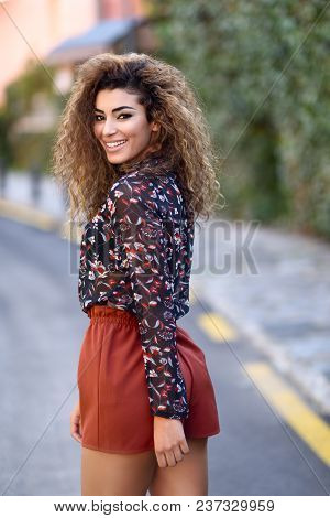Happy Young Arabic Woman With Black Curly Hairstyle.