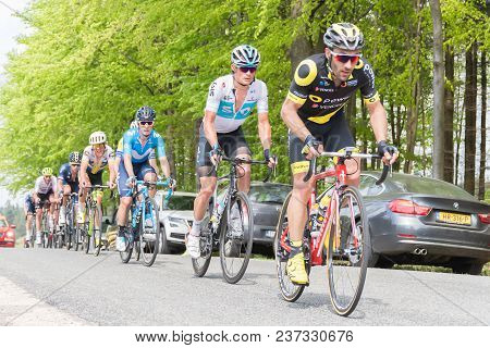 Vielsalm- Belgium, April 22, 2018: Cyclists Compete Riding Rapid And Pass The Nature Forest In Sunny