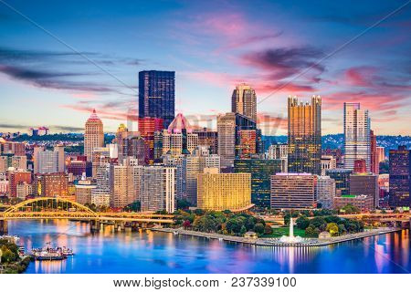 Pittsburgh, Pennsylvania, USA downtown city skyline on the rivers at dusk.