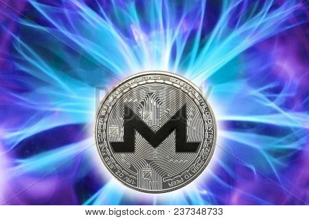 Birth Or Fork Of Monero Cryptocurrency. Coin Background Real Cold Plasma.