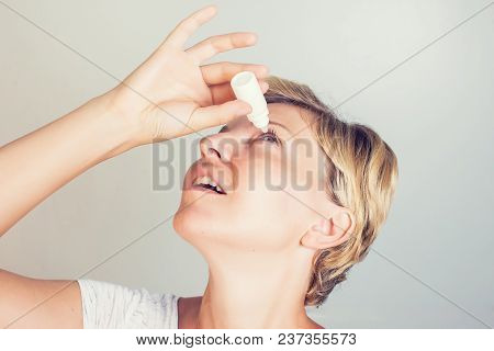 A Woman Using Eye Drops In Eyes