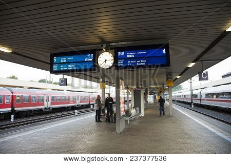 People Walk And Wait With Train Stopping In Terminal For Send And Receive Passengers At Mannheim Hau