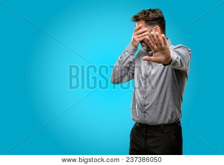 Middle age man, with beard and bow tie stressful and shy keeping hand on head, tired and frustrated