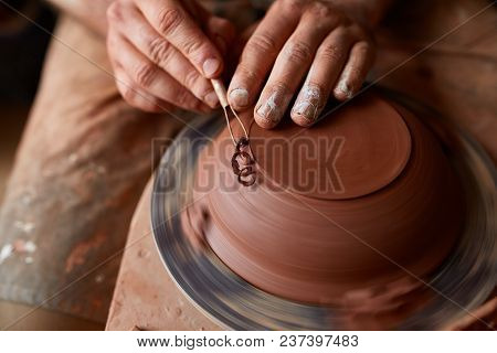 Close-up Hands Of A Male Potter In Plaid Shirt And Dirty Apron Who Molds A Vase From Clay, Selective