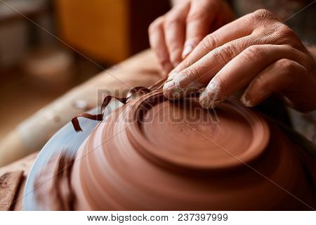 Close-up Hands Of A Male Potter In Plaid Shirt And Dirty Apron Who Molds A Vase From Clay, Selective