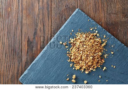 Healthy Mix Of Granola And Oatmeal On Dark Background, Top View, Close-up, Selective Focus. Abstract