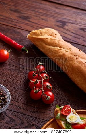 Breakfast Sandwich With Homemade Paste, Vegetables And Fresh Greenson Wooden Cutting Board Over Rust