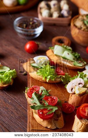 Breakfast Sandwich With Homemade Paste, Vegetables And Fresh Greenson Wooden Cutting Board Over Rust