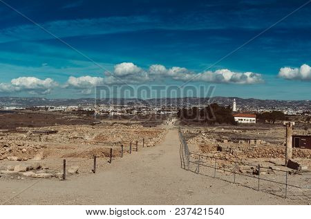 Ancient Ruins Of Kourion City Near Pathos And Limassol, Cyprus. Ruins And Road Under Blue Sky. Trave