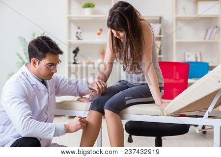 Doctor checking patients joint flexibility