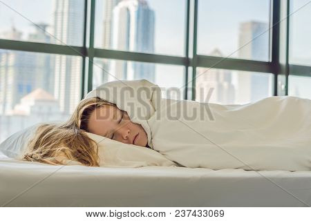 Woman Wakes Up In The Morning In An Apartment In The Downtown Area With A View Of The Skyscrapers. L