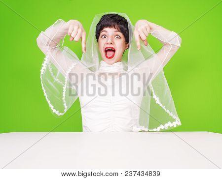 Excited Bride In Wedding Attire Pointing With Her Fingers. Portrait Of A Girl Pointing Thumbs Down. 