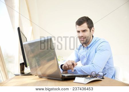Casual Businessman Working On Laptop