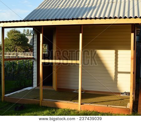 Wooden Veranda, Terrace In Rustic Country House On Grass Background