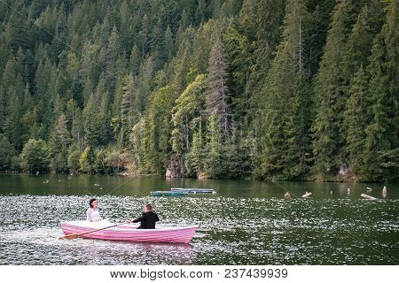 Bucharest, Romania - September 9, 2017: Couple Boating On Lacu Rosu Or Red Lake In Eastern Carpathia