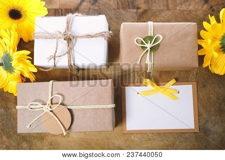 Little Gift Boxes With With Yellow Flowers In A Rustic Style
