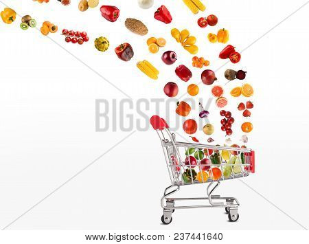 Grocery Cart With Vegetables And Fruits Falling In It Isolated On White. Healthy Meals Shopping, Cor