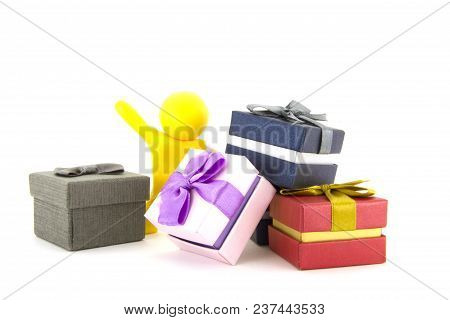 Yellow Plasticine Character And Gift Boxes On White Background. Present Boxes. Holidays Concept.