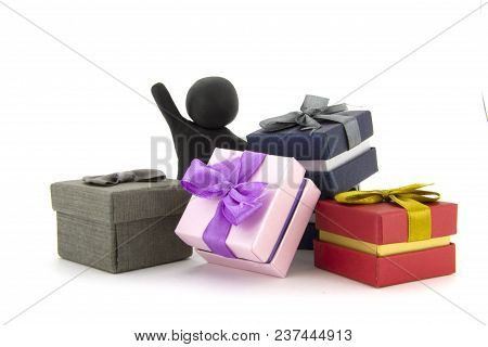 Black Plasticine Character And Gift Boxes On White Background. Present Boxes. Holidays Concept.