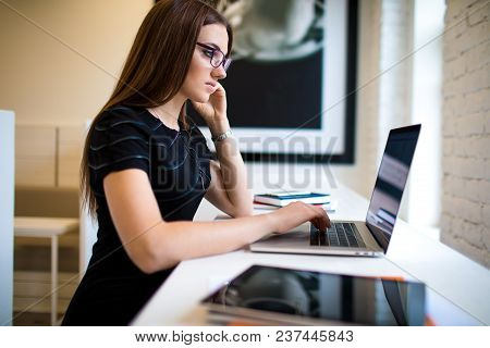 Woman In Glasses Successful Marketing Specialist Searching Information On Portable Laptop Computer, 