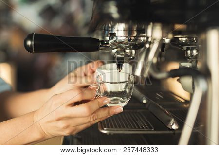 Experienced Barman Making Espresso In Modern Coffee Machine. Closeup Of Female Hand Preparing Bracin