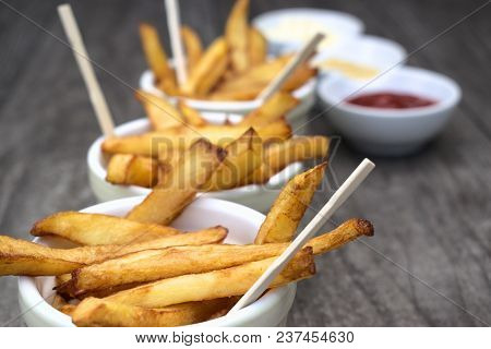 Tasty Food, Nutrition, Kitchen And Culinary Concept: Homemade Fries In Bowls For Snacks On Wooden Ba