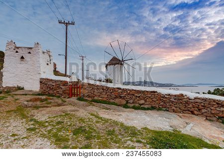 White Windmill On A Hill Above The City Chora On Sunset. Mykonos. Greece. Chora.