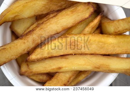 Tasty Food, Nutrition, Kitchen And Culinary Concept: Homemade Fries In Bowl For Snacks On Wooden Bac