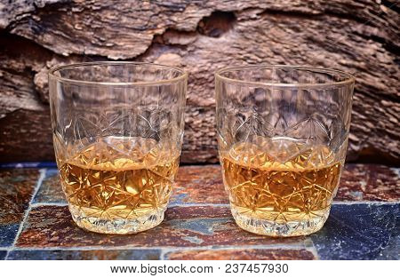 Alcohol,taste And Drink Concep-two Glasses Of Whisky On A Old Stone Background.