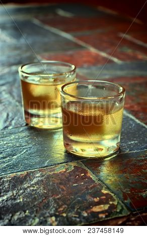 Alcohol,taste And Drink Concep-two Glasses Of Whisky On A Old Stone Background.