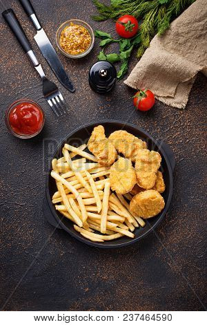French Fries And Chicken Nuggets With Sauces. Top View