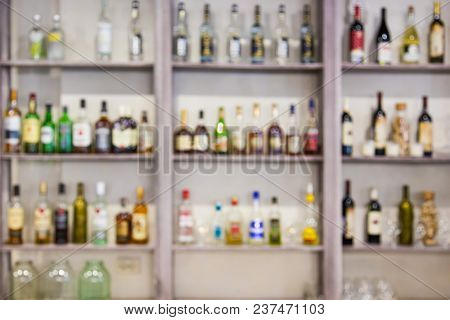 Blurred Background From Bottles With Alcohol On The Shelves In The Bar