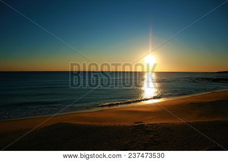 Sunset At Beach Over Gold Sand Mixing Colors In Caños De Meca,cadiz,spain.