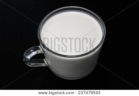 Cup With Yogurt On A Black Table