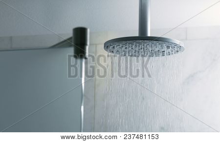 Shower turned on, ceiling shower head closeup