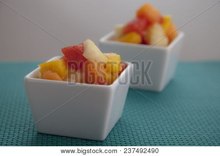 Fruit Salad Mix Of Melon, Banana, Watermelon, Orange And Pineapple In A Small Porcelain Bowl, Breakf