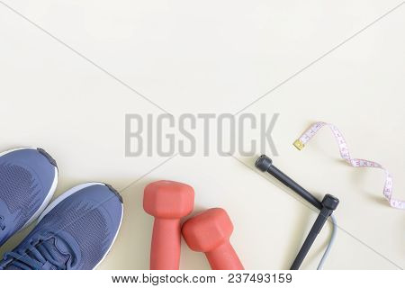 Sneakers, Red Dumbbells, A Skipping Rope And A Centimeter Tape. Fitness Background With Place For Te