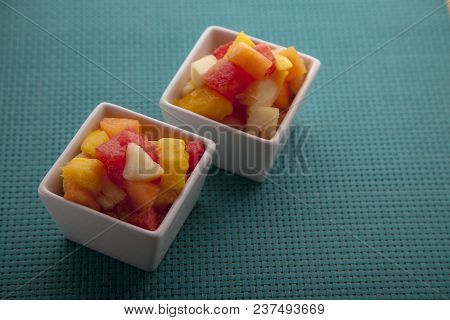 Fruit Salad Mix Of Melon, Banana, Watermelon, Orange And Pineapple In A Small Porcelain Bowl, Breakf