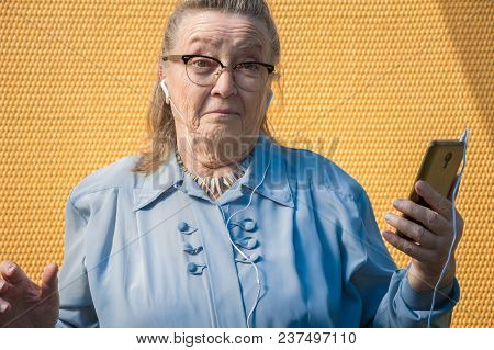 Portrait Of Old Lady, Grandmother Makes Selfie Outdoors At Sun Day. Modern Caucasian Granny Finger  