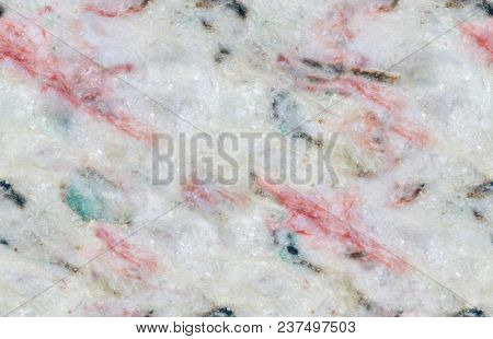 grey and red listvenite mineral texture closeup